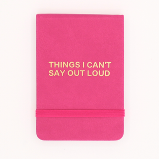 Pink notebook with 'THINGS I CAN'T SAY OUT LOUD' text on a white background