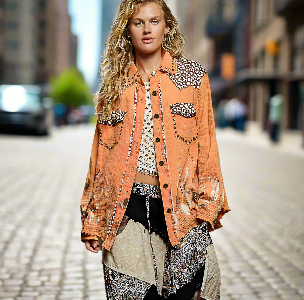 Woman wearing a patterned orange jacket on a city street