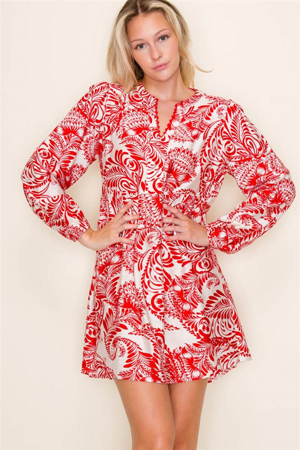 Woman wearing a red and white patterned dress against a plain background
