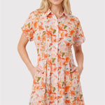 Woman wearing a floral dress on a plain background