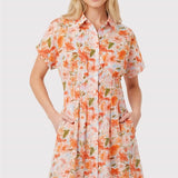 Woman wearing a floral dress on a plain background