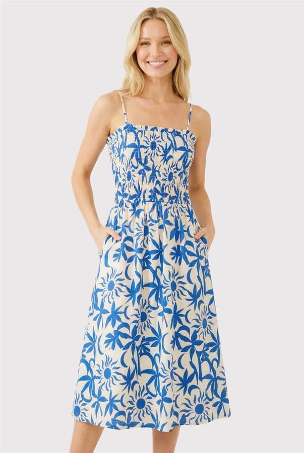 Woman wearing a blue floral dress on a white background