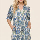 Woman wearing a floral dress with a beige background