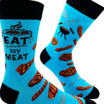 Blue socks with grill and meat designs on a white background