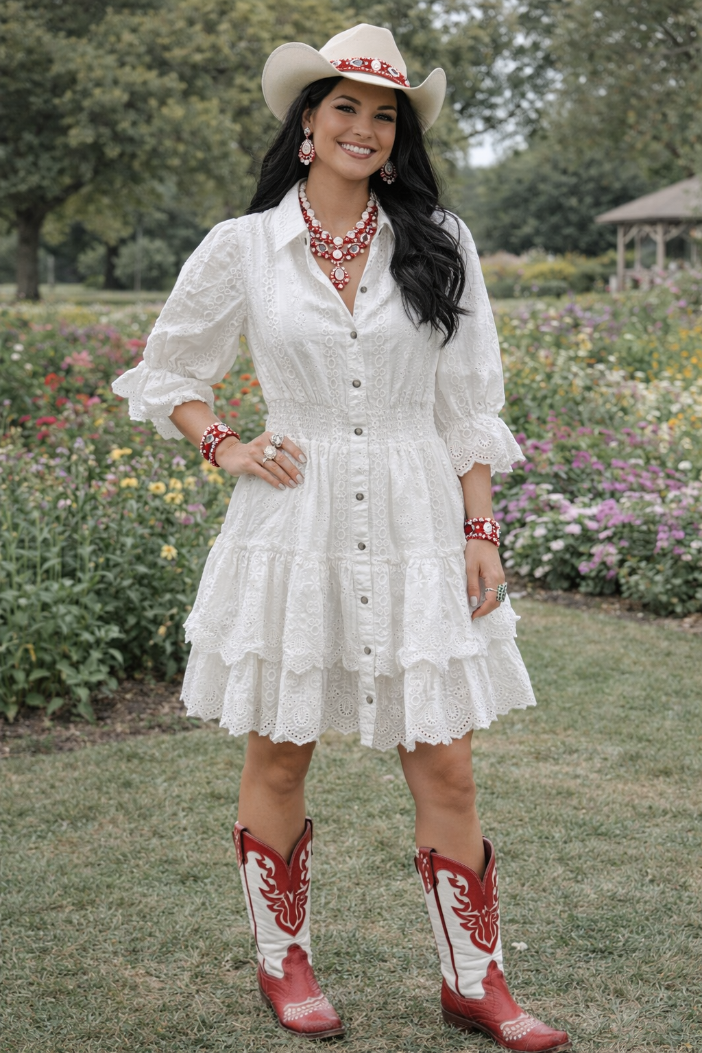 Woman in a white dress and red cowboy boots standing in a garden.