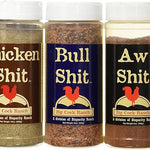 Five containers of Big Cock Ranch seasoning with colorful labels.