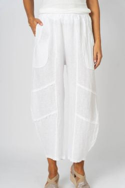 A pair of white linen pants with flat front pockets and details on the knee area. The pants are made in Italy.