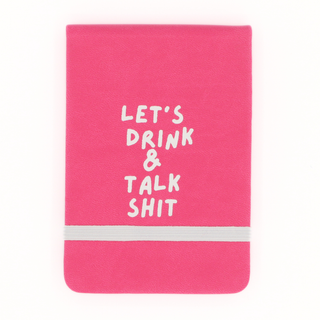Pink notebook with white text 'LET'S DRINK & TALK SHIT' on a white background