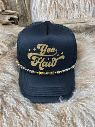 Black cap with 'Yee Haw' in gold glitter on a fur surface
