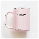Pink mug with text 'i use bad words' on a white background