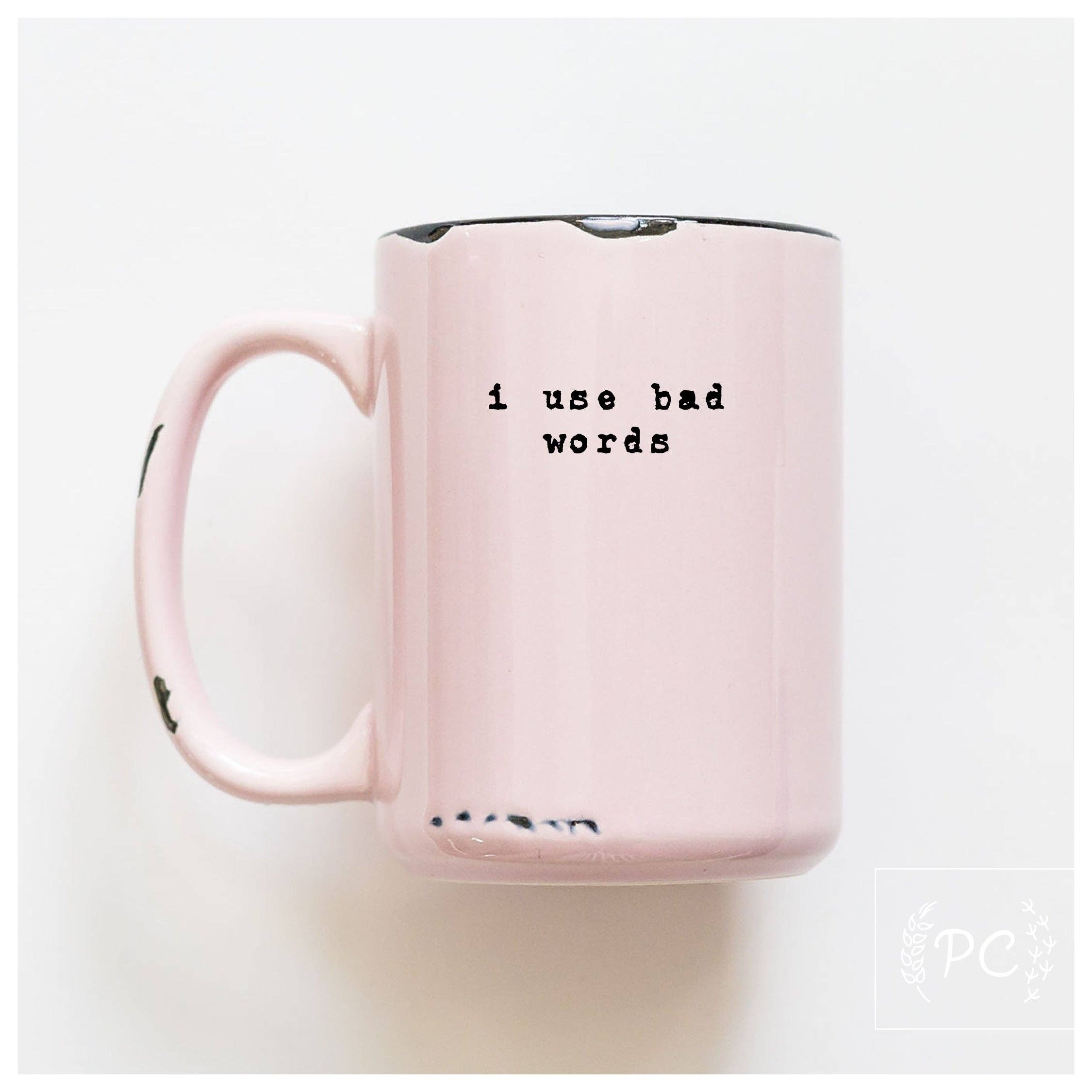Pink mug with text 'i use bad words' on a white background