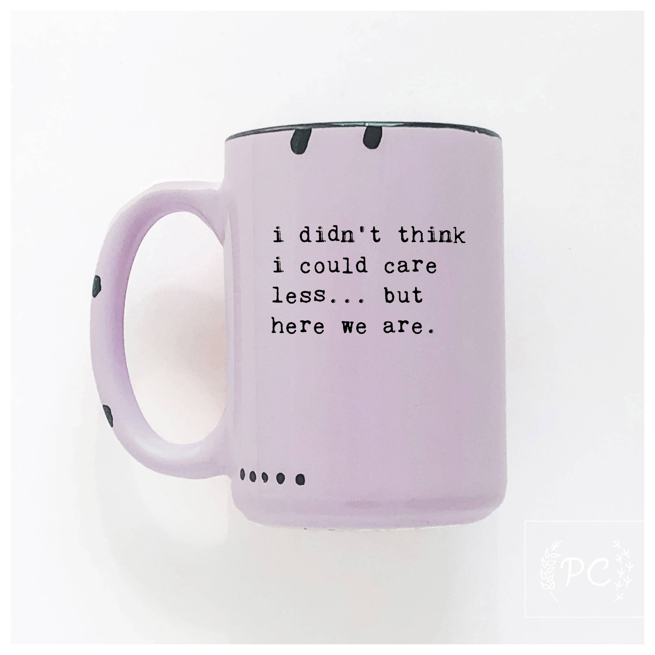 Purple mug with text 'i didn't think i could care less... but here we are.' on a white background