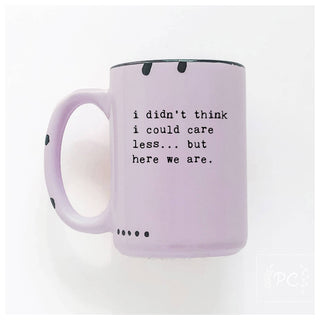 Purple mug with text 'i didn't think i could care less... but here we are.' on a white background