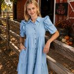 GAL IN BLUE DRESS IN FRONT OF RED BARN
