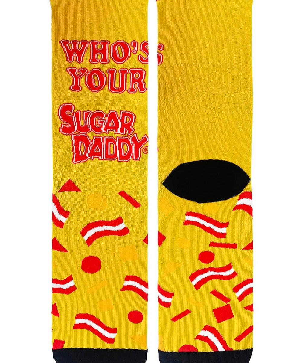 A pair of men's crew socks with yellow background and text 'WHO'S YOUR SUGAR DADDY' written on them, along with decorative red and white stripes.
