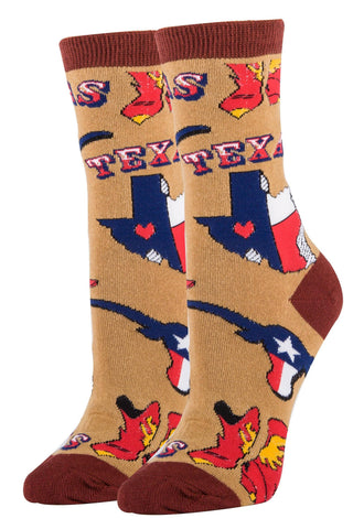 A pair of women's cotton crew socks with a novelty Texas design, featuring red and blue colors and the word 'Texas' on a light brown background.