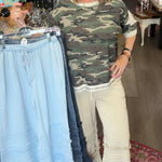 MODEL IN RUFFLE BOTTOM PANTS AND CAMO SHIRT
