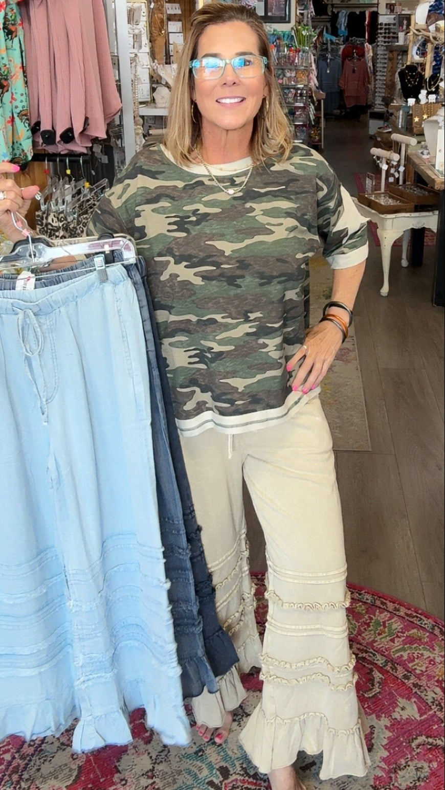 MODEL IN RUFFLE BOTTOM PANTS AND CAMO SHIRT
