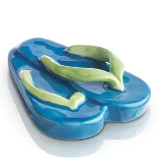 Blue and green flip-flop-shaped soap dish on a white background