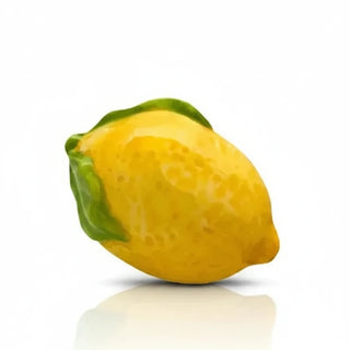 Yellow lemon with green leaf on a white background