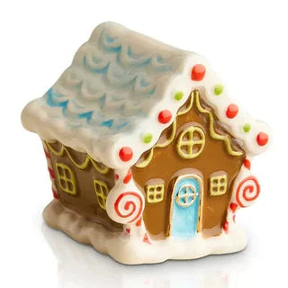 Gingerbread house-shaped cookie jar with decorative elements on a white background