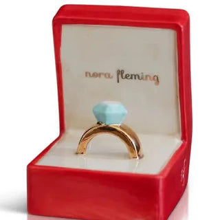Gold ring with a blue gemstone in a red 'nora Fleming' box