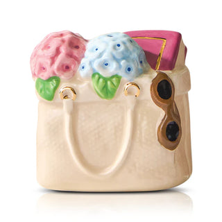 Decorative ceramic handbag with floral design on a white background