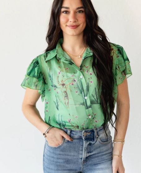 Woman wearing a green floral blouse and blue jeans on a white background