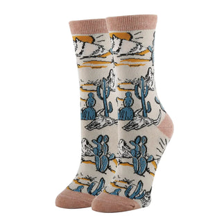 Sock with desert-themed design featuring cacti and landscapes on a white background