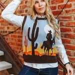 Woman wearing a sweater with desert design against a brick wall