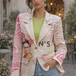 Woman wearing a patterned jacket with a design of a woman's face and the number 5, standing outdoors.