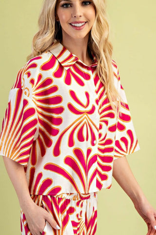 Woman wearing a colorful patterned outfit on a light green background