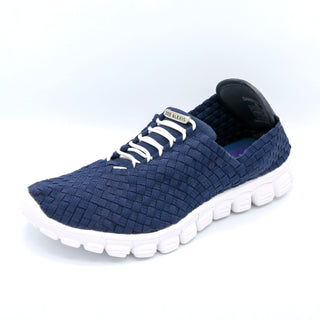 Navy blue textured sneaker with white sole on a light gray background