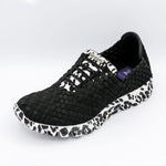 Black and white sneaker with woven pattern on a light gray background