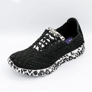 Black and white sneaker with woven pattern on a light gray background