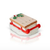 Miniature toy boat with a wooden deck and red frame on a white background