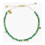 Green beaded necklace with gold accents on a white background