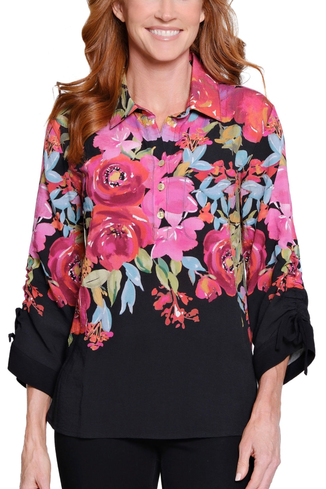 Woman wearing a black blouse with colorful floral patterns on a white background
