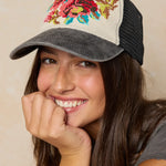 Woman wearing a colorful floral embroidered cap on a beige background