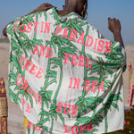 Person wearing a patterned garment with text in a desert setting