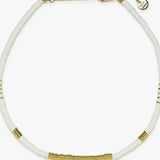Necklace with white beads and gold accents on a white background