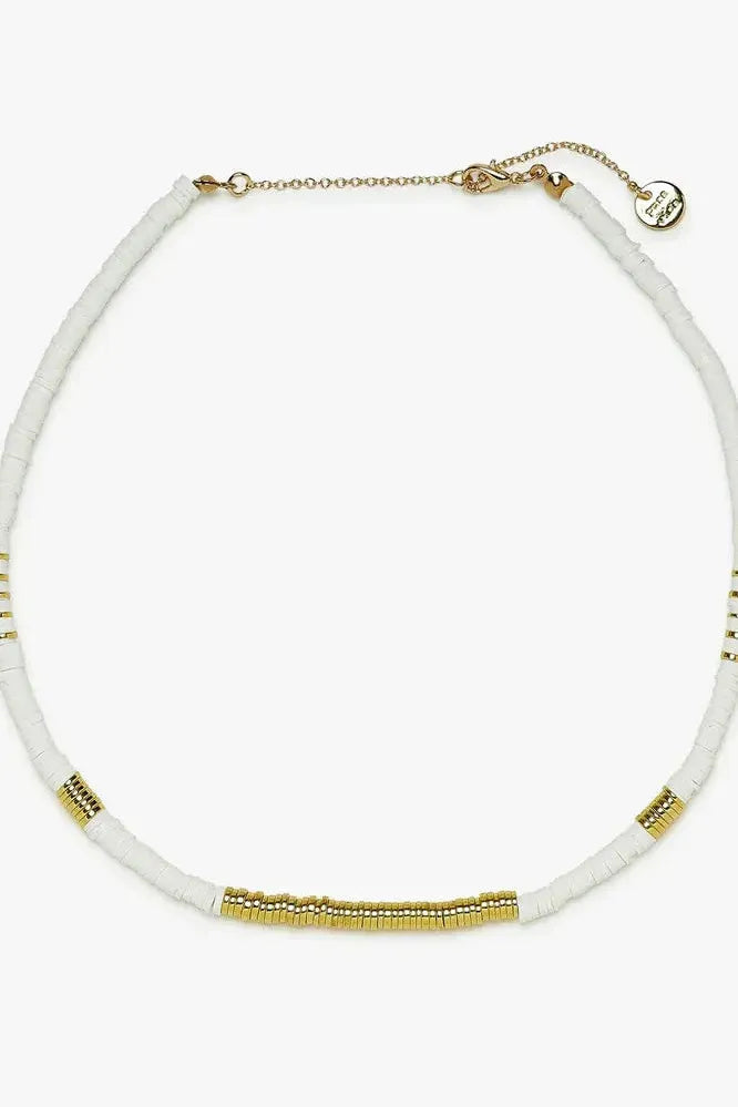Necklace with white beads and gold accents on a white background