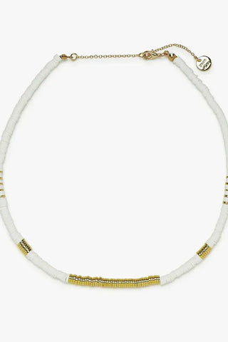 Necklace with white beads and gold accents on a white background
