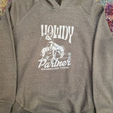 Gray hoodie with 'Howdy Partner' graphic on a colorful floral background