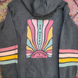 Gray hoodie with colorful design on the back against a patterned fabric background