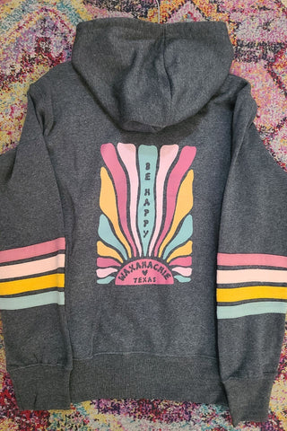 Gray hoodie with colorful design on the back against a patterned fabric background