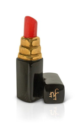 Lipstick with gold cap and black casing on a white background