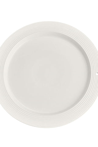 White ceramic plate with decorative rim on a white background