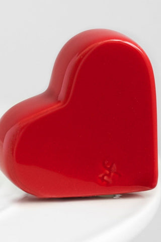Red heart-shaped object on a white background