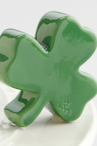 Green ceramic four-leaf clover on a white background